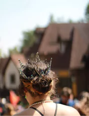 the back of Selena's head wearing a crown at the Renaissance Faire