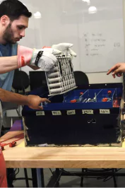 Photo of Jack placing a segment of lithium ion cells into the accumulator for the electric car.