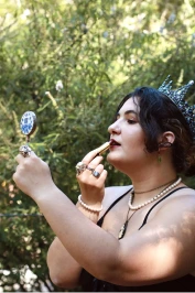 Selena applying lipstick at the Renaissance Faire.